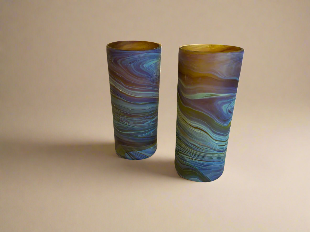 Two cylindrical glass vases with swirling blue and green pattern Phoenician hebron tall tumblers brown blue honey