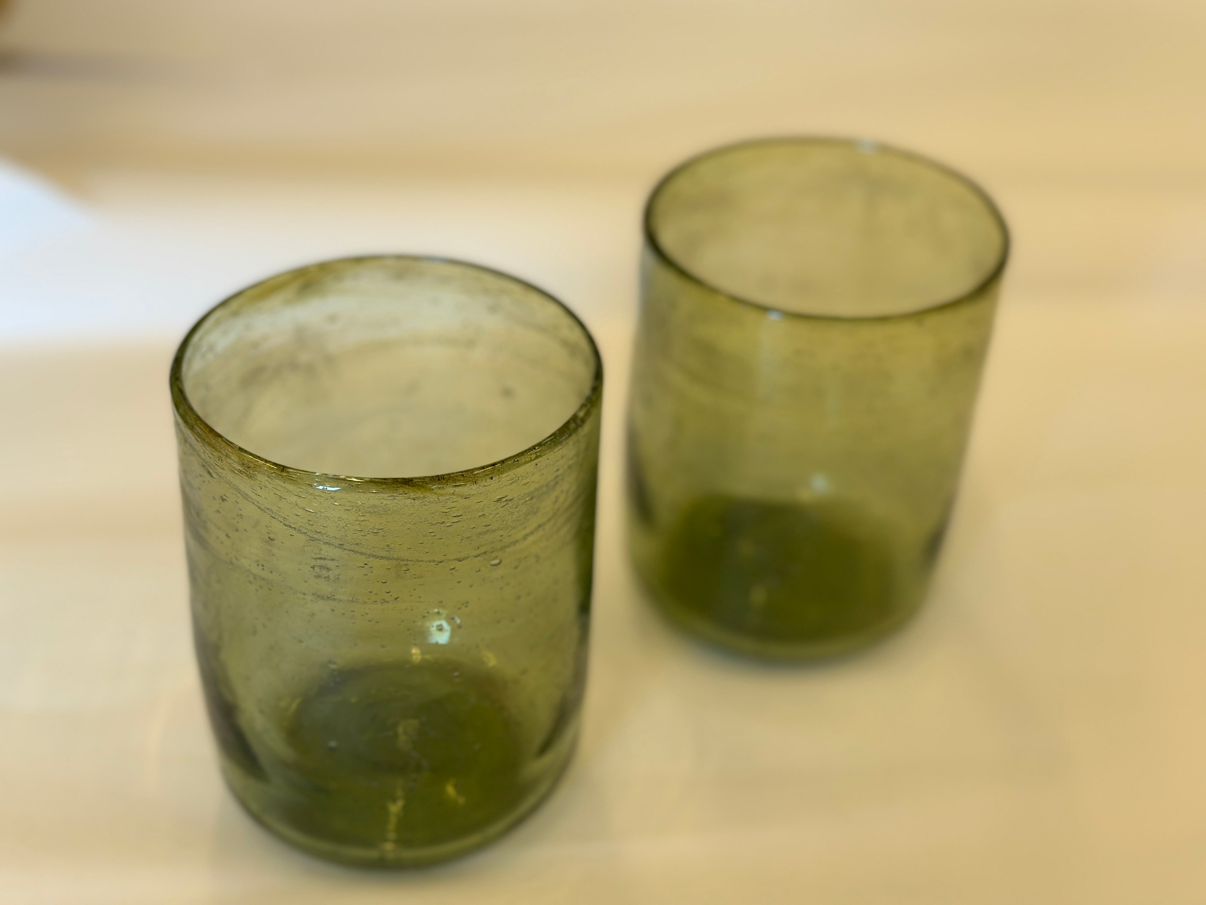 Two green glass tumblers