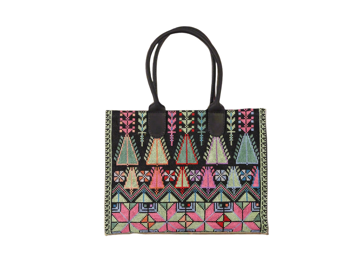 Tote bag with geometric hand embroidered pattern on a white background