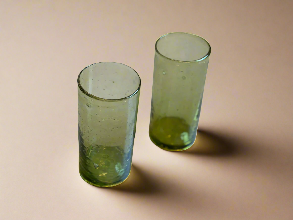Two green glass tumblers