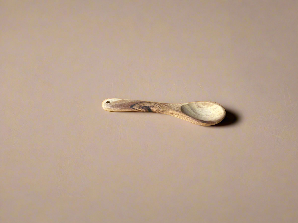 Wooden spoon on a beige background