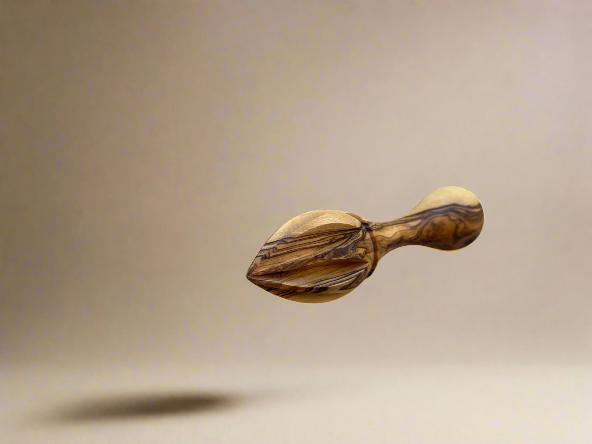 Olive wood lemon citrus reamer on a white background