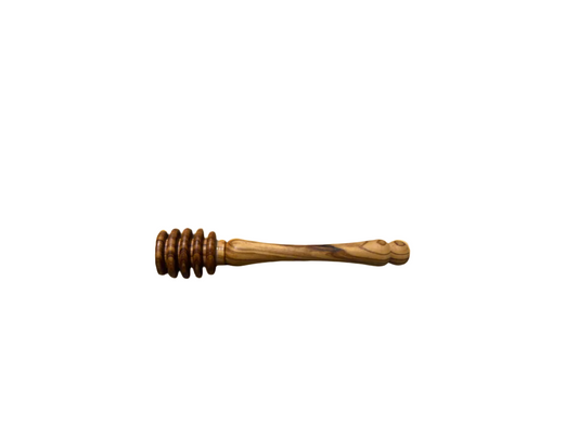 Olive wood honey dipper on a beige background